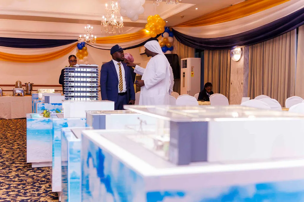 Guests discussing Oriental Royal Estates developments beside architectural models
